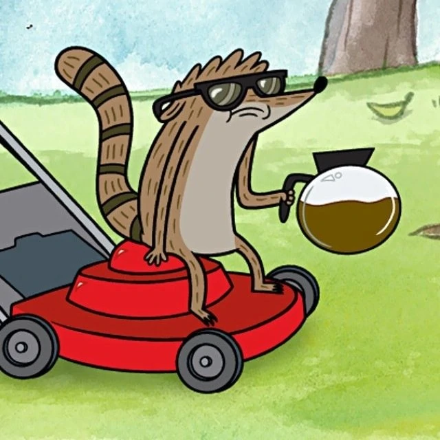 Rigby relaxing on a lawn mower.